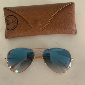 Light blue ray bans with gold trim